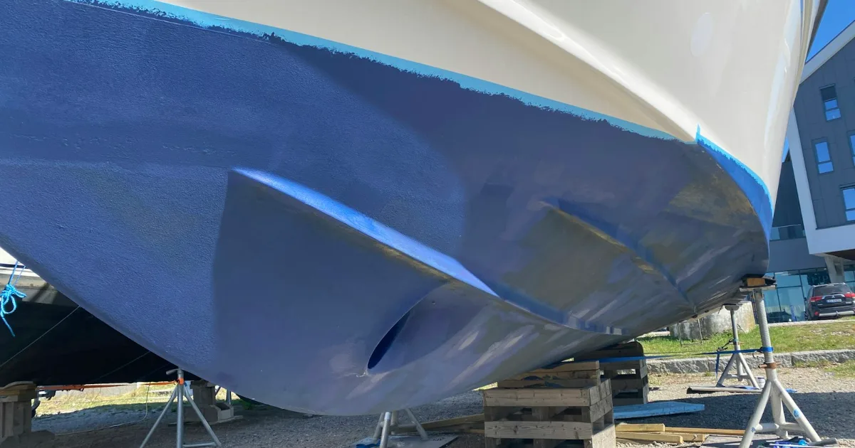 Boat hull being repaired with fiberglass and epoxy – illustrative composite lamination photo