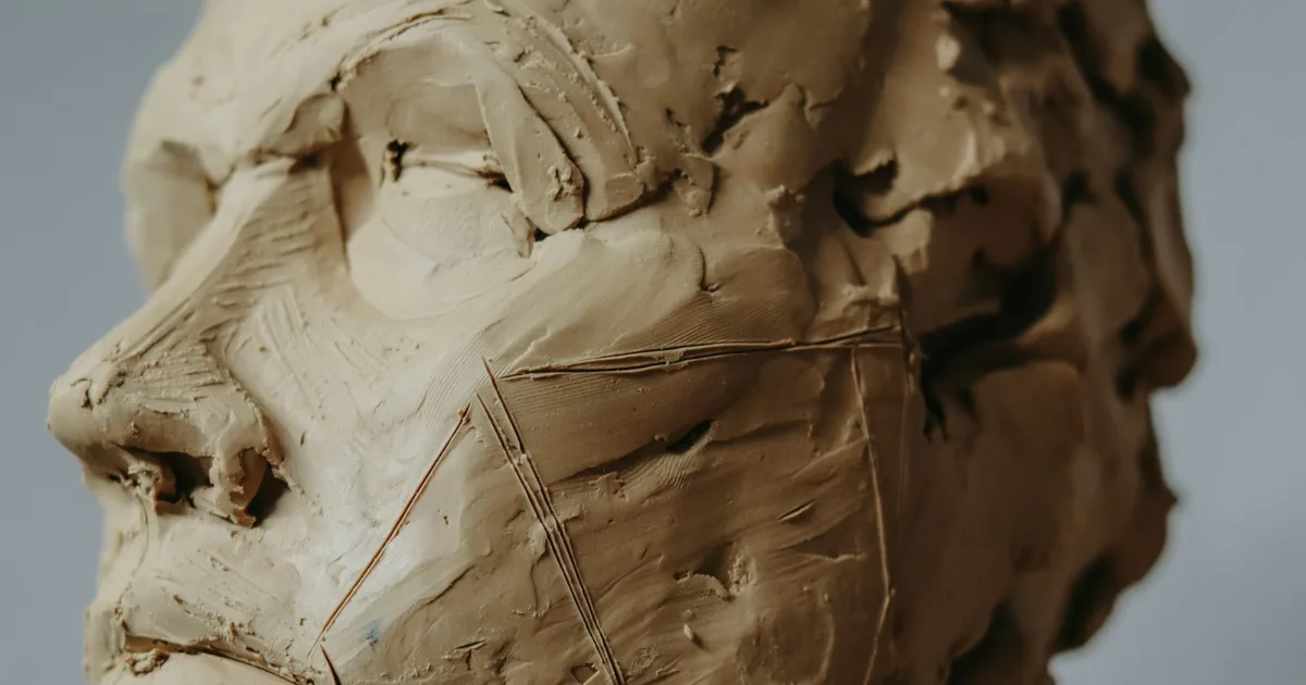 Unfinished clay portrait head sculpture – illustrative example of a hand-sculpted statue original